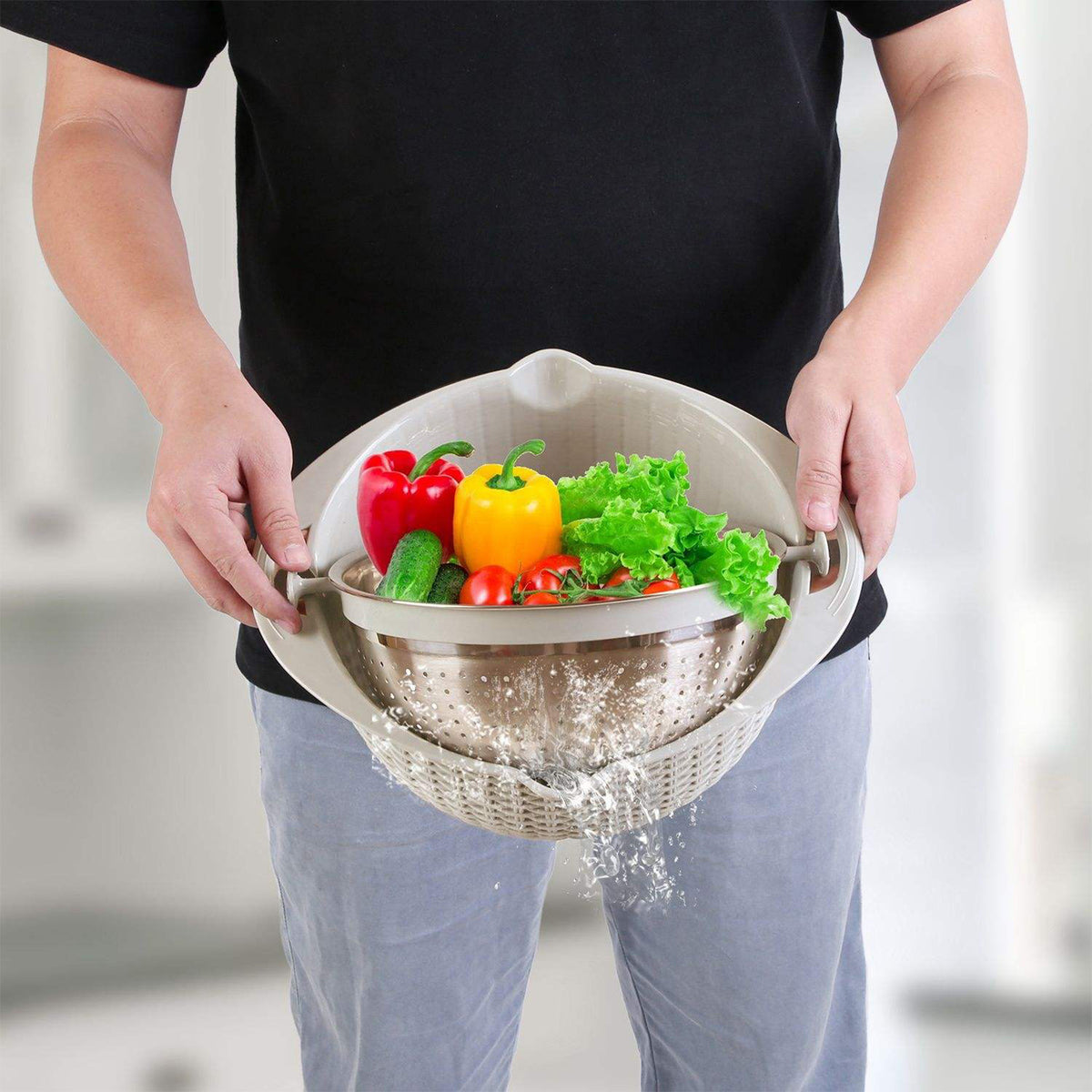 Person holding a colander with vegetables in a kitchen setting